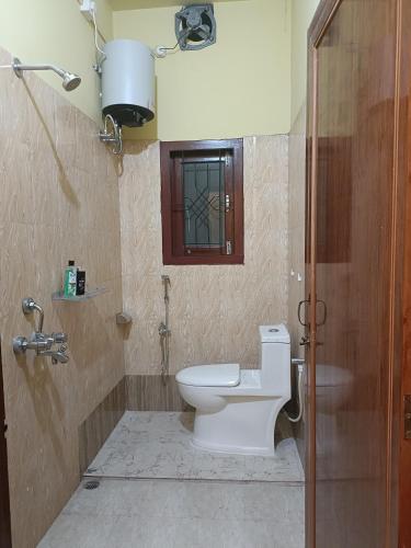 a bathroom with a toilet and a sink at 'Nijor Homestay' Your own Charming & Relaxing 1BHK in Dispur