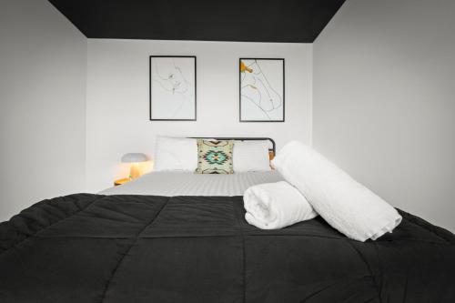a bedroom with a large bed with two pillows at The Outlook on Mount Louis - Stunning Views in Tinderbox