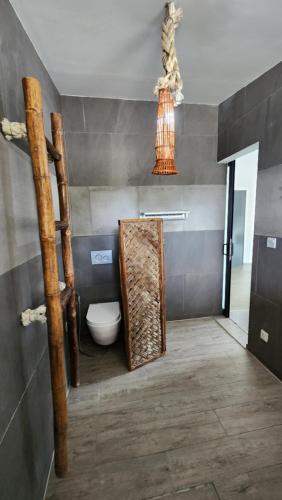a bathroom with a toilet and a staircase in a room at Eagle Bay Retreat Borneo Beach Villas Beach Front in Kumbatang
