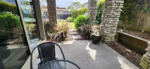 a patio with a table and a chair on a porch at Central Retreat in Taupo