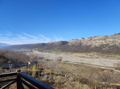 a view of a hill with a field and a river at The River View Villa الحلال Halal Concept in Quba