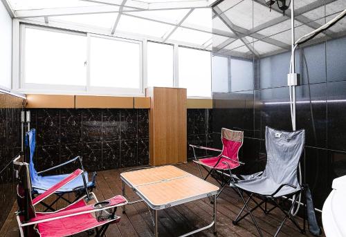 a group of chairs and a table in a room at Zenith Hotel in Guri