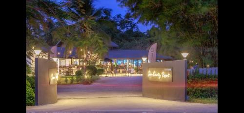 a house with a gate in front of it at night at Siam Country Resort in Nong Prue