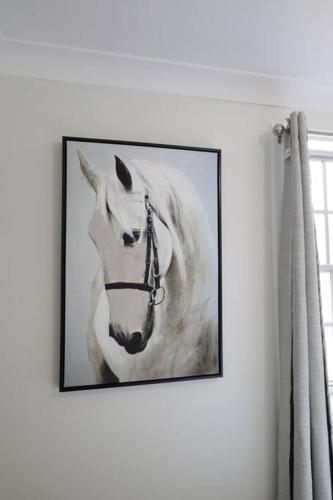 a painting of a white horse on a wall at Country 4-Bed Homestead with Games Room & Views in Tenterfield