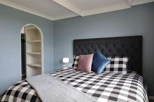 a bedroom with a black and white checkered bed at Country 4-Bed Homestead with Games Room & Views in Tenterfield