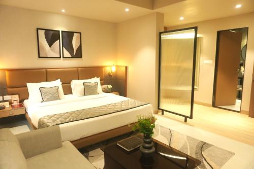 a hotel room with a bed and a couch at SIVANTA by BOMBAY GROUP OF HOTELS NAGPUR in Nagpur