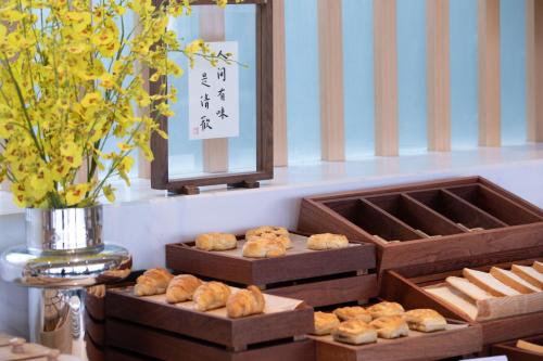 two boxes of pastries on a table with a mirror at Atour Hotel Chengdu Sichuan Normal University in Chengdu