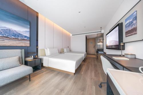 Ένα ή περισσότερα κρεβάτια σε δωμάτιο στο Atour Hotel Dazhou Renhe New Town East Baqu Road