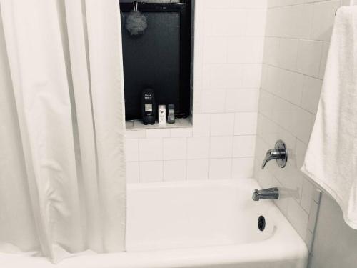 a bathroom with a white tub and a sink at Entire Apartment in heart of Lincoln Park & Lake Sea and beach in Chicago
