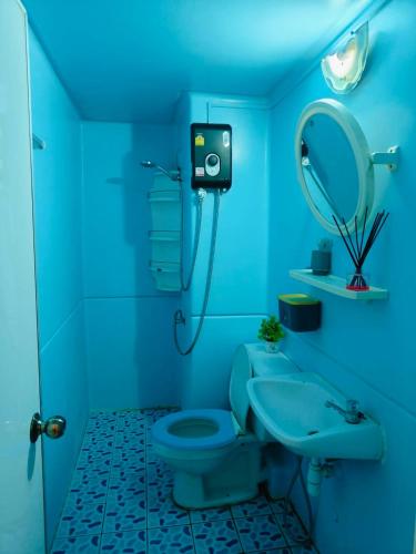 a blue bathroom with a toilet and a sink at SimpleRoomDesign, VeryClose Impact Muaungthongthani in Thung Si Kan
