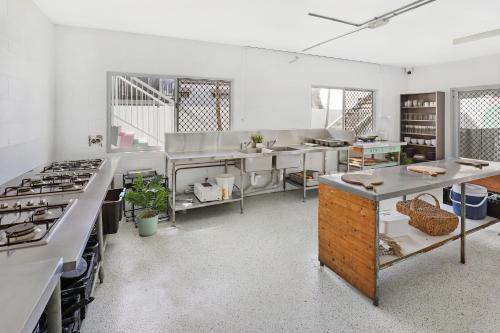 a large kitchen with a lot of counters and tables at Palms on Parker Backpackers in Maroochydore
