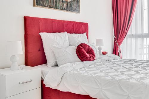 a bedroom with a red headboard and a white bed at ARI - ARED Luxurious Apartments with Balcony & Free Parking in Arad