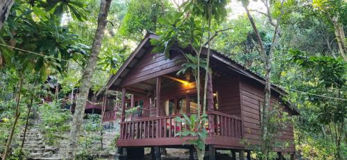 a small wooden cabin in the woods with trees at Sambath Sakseth Bungalow in Koh Rong Island