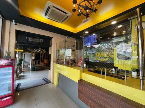 a fast food restaurant with a yellow counter at Smile Hotel Wangsa Maju in Kuala Lumpur