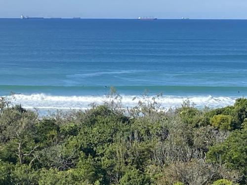 a view of the ocean from the top of a hill at Breathtaking Beachfront 3 Bedroom Penthouse Bokarina Sunshine Coast in Bokarina