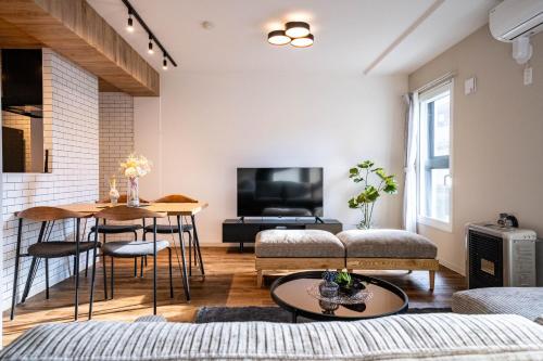 a living room with a couch and a table at Zabo Hills 203 in Sapporo