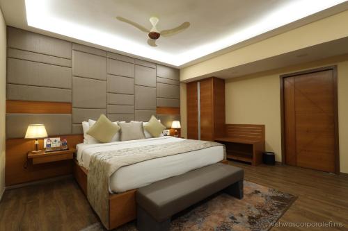 a bedroom with a bed and a ceiling fan at Rang Lords Inn Bharuch in Bharuch