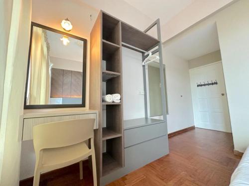 a dressing room with a mirror and a chair at Century Suria Seaview + 3 Bedroom Apartment in Kuah