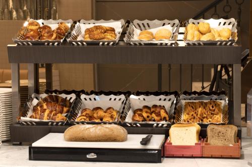 a display of different types of bread and pastries at Me by Mula in Istanbul