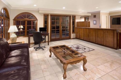 a living room with a couch and a coffee table at Travelodge by Wyndham Costa Mesa Newport Beach Hacienda in Costa Mesa