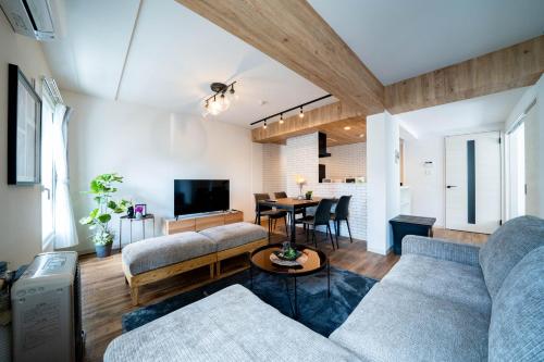 a living room with two couches and a table at Zabo Hills 205 in Sapporo