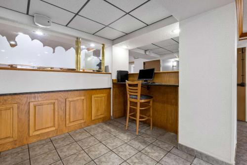 an office with a bar with a chair and a desk at Quality Inn near Monument Health Rapid City Hospital in Rapid City