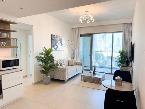 a living room with a couch and a table at INA HOMES - 1BHK Downtown Views Direct Access to Dubai Mall in Dubai