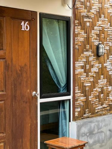 a door with a number next to a building at The Canopy Krabi in Ao Nang Beach