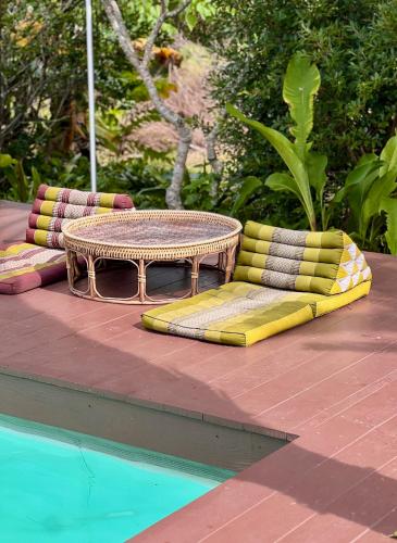 a table and chairs sitting next to a pool at The Canopy Krabi in Ao Nang Beach