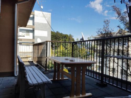 a wooden table and a bench on a balcony at Bibi Vacation Rental Only 2 groups per day Vacation STAY 1284 in Sakai