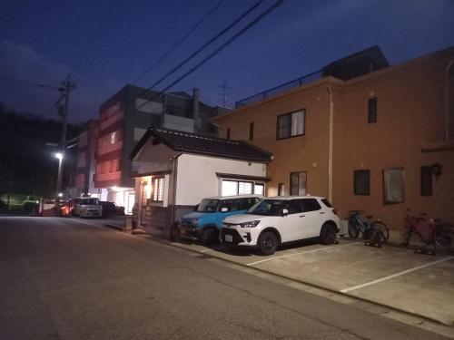 two cars parked in a parking lot next to a building at Bibi Vacation Rental Only 2 groups per day Vacation STAY 1284 in Sakai