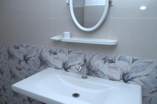 a bathroom with a sink and a mirror at Lavinia Blue Hotel in Mount Lavinia