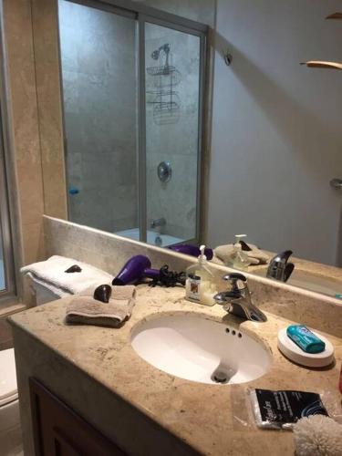 a bathroom with a sink and a shower at Super Condo 1 en Vidanta in Nuevo Vallarta