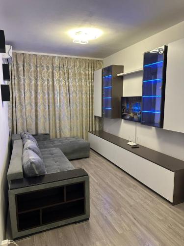 a living room with a couch and a tv at Alex Mnl Lux Apartment free parking D12 in Bucharest