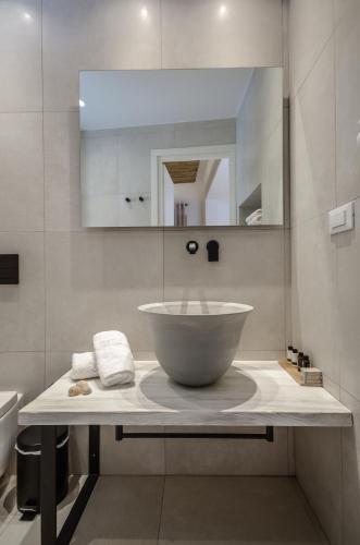 a bathroom with a bowl sink and a mirror at Thomais Studios in Naxos Chora