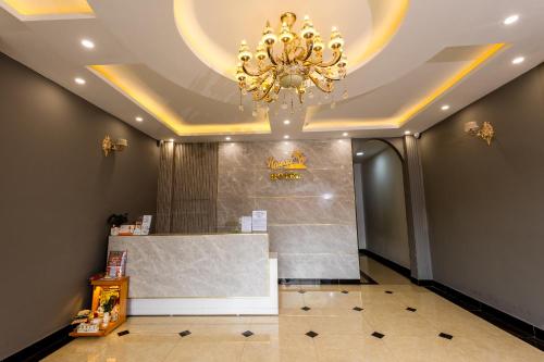 a room with a chandelier on the ceiling and a counter at Hawaii Hotel Dalat in Da Lat