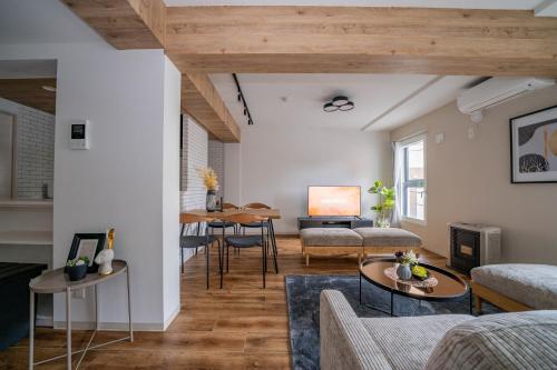 a living room with a couch and a table at Zabo Hills 303 in Sapporo