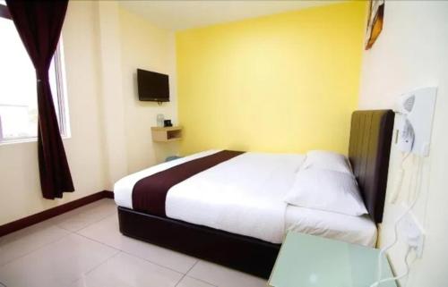 Ένα ή περισσότερα κρεβάτια σε δωμάτιο στο Sg Pelek Hotel