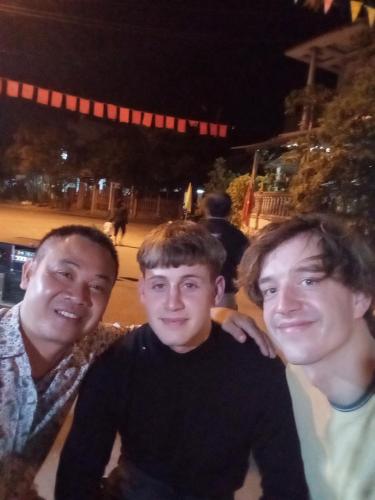 three men posing for a picture at night at Seamist Ocean Villa in Hoi An