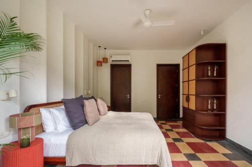 a bedroom with a bed and a dresser at La Verona - 2,3,4 BHK Villas in Assagao with Private Pool, Garden, Caretaker, Kitchen & Security in Assagao