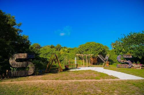 a park with a playground with a swing at Salty's Kitesurf Village in Kilifi