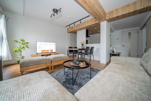 a living room with two couches and a table at Zabo Hills 305 in Sapporo