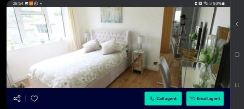 a bedroom with a white bed and a window at Hartgrove in Gurnard