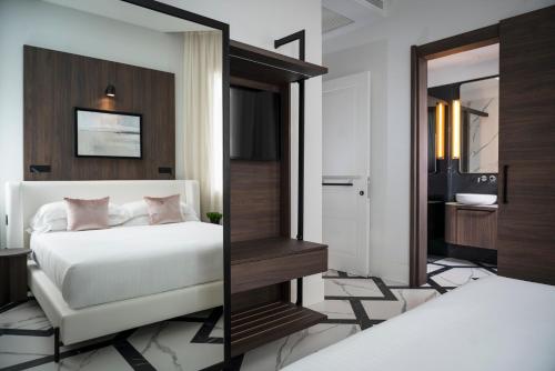 a bedroom with a bed and a mirror at Casa Riva in Riccione