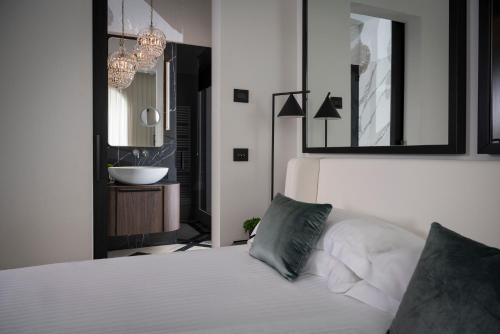 a bedroom with a white bed with two pillows at Casa Riva in Riccione