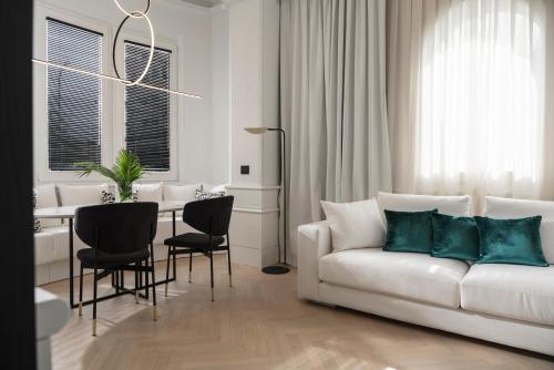 a living room with a white couch and a table at Casa Riva in Riccione