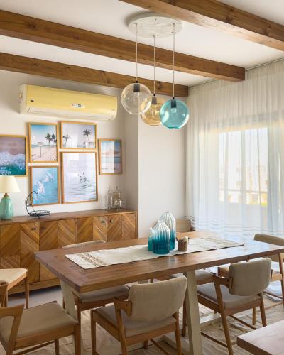 a dining room with a wooden table and chairs at El Gouna - BIRD NEST in Hurghada