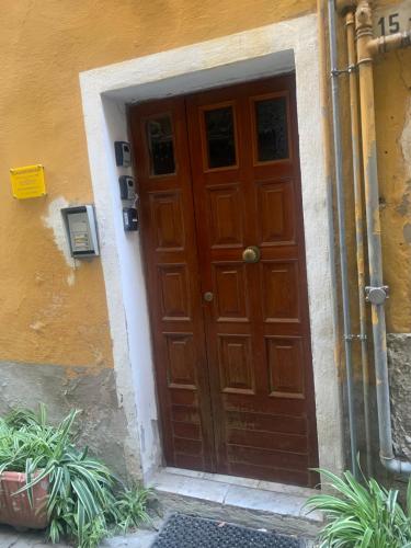 a wooden door in the side of a building at CASABARBARA lerici in Lerici