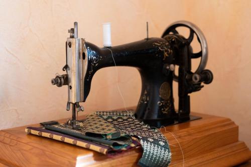 a black sewing machine sitting on top of a table at Residence Moritz with Sauna in Mozirje