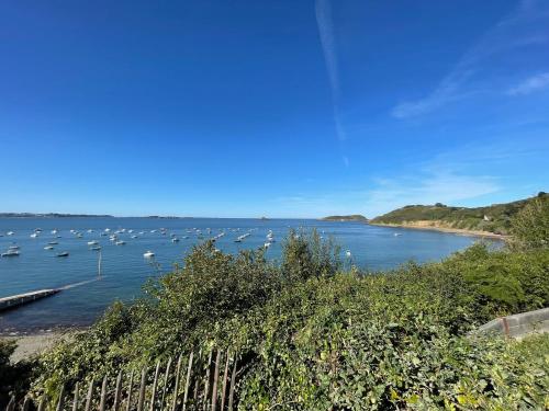 a view of a harbor with boats in the water at Ty Heole House in Plouézec